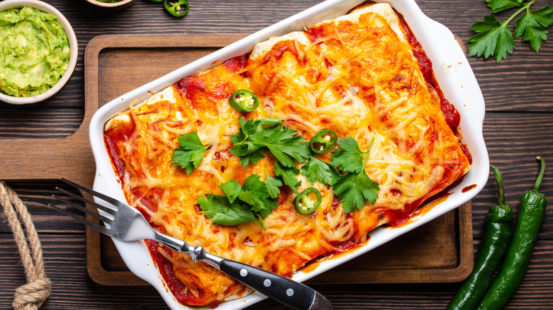 Red enchiladas in white pan