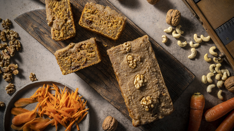 Carrot bread slices next to loaf and shredded carrots