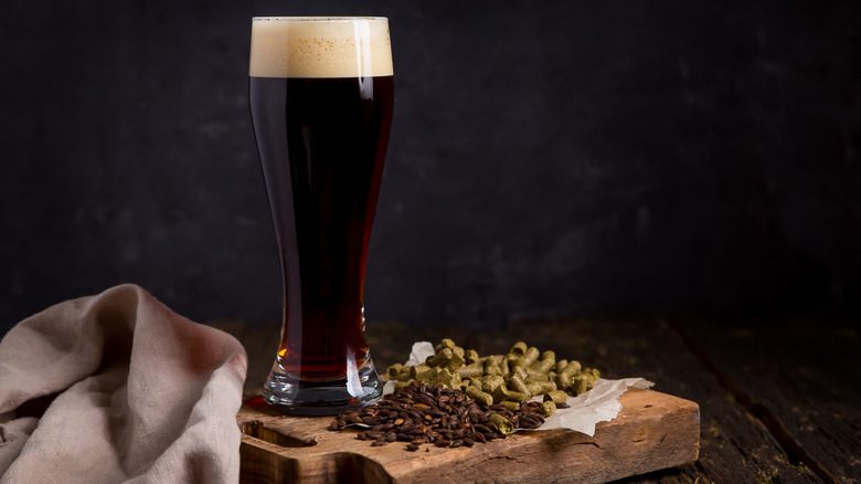 Glass of chocolate beer and two snacks