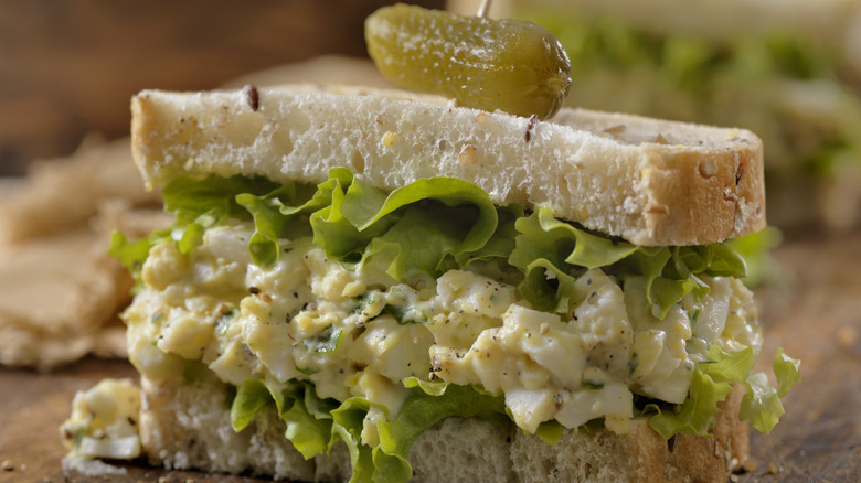 Egg salad sandwich with lettuce and pickles