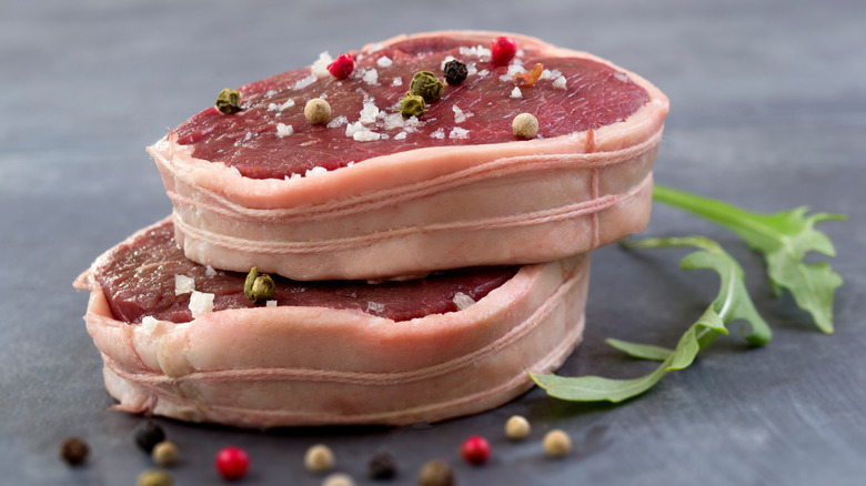 raw steaks with twine