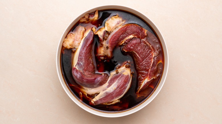 Meat cuts marinating in bowl