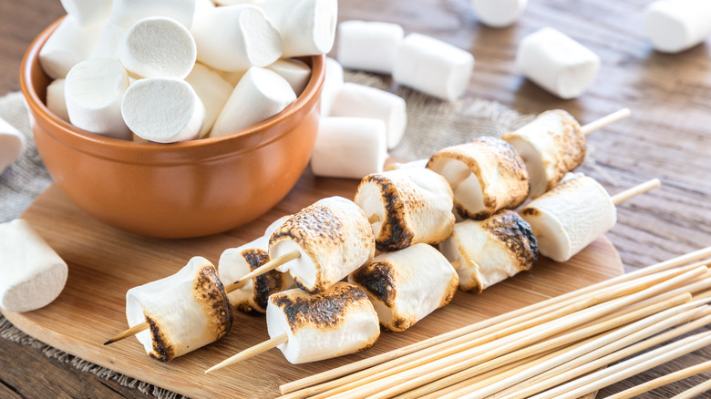 Marshmallows in bowl and toasted on skewers