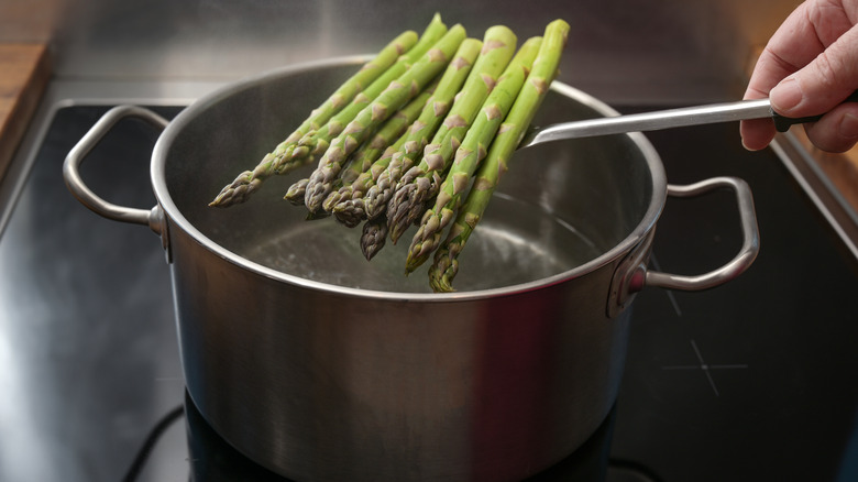 Woman blanching asparagus before freezing it