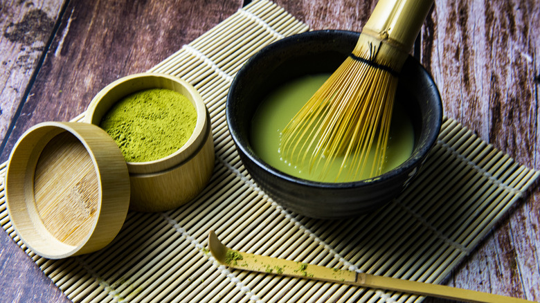 whisking matcha tea in bowl