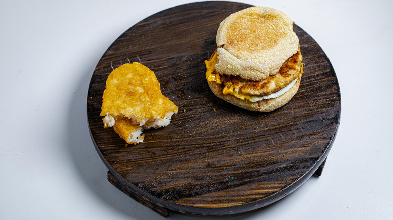 Sausage Egg McMuffin with hash brown on board