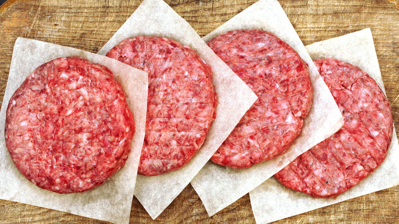 Four raw beef patties