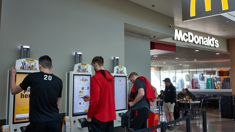 McDonald's customers ordering from kiosks