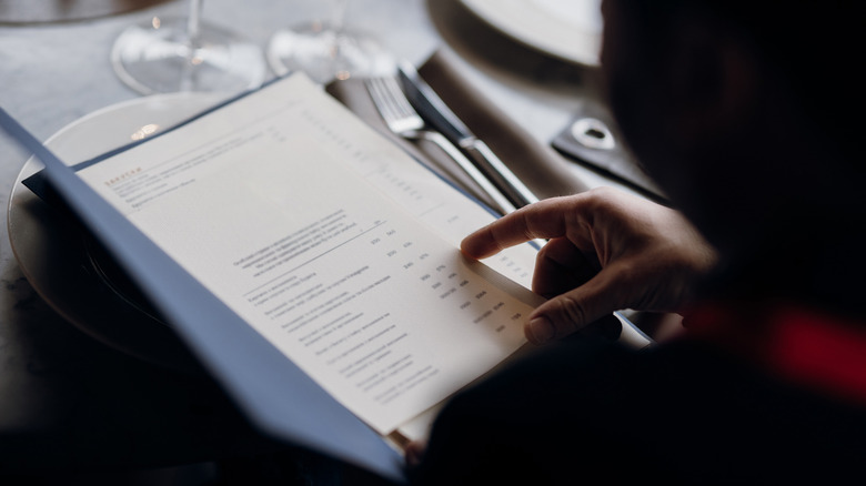 Person looking at a restaurant menu