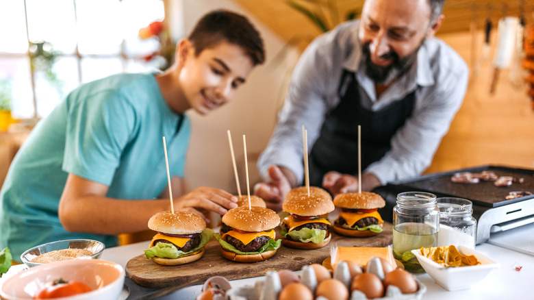 family cooking cheesburgers