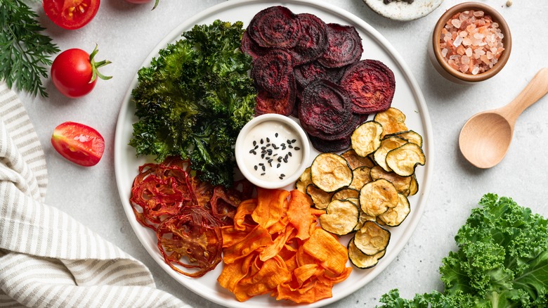 Variety of veggie chips arranged around dip