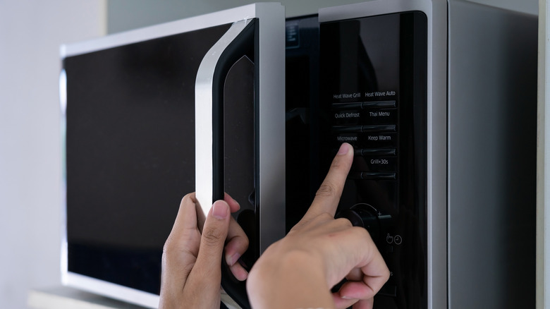 Person turning on a microwave