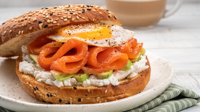 egg on a bagel with lox, cream cheese, and avocado