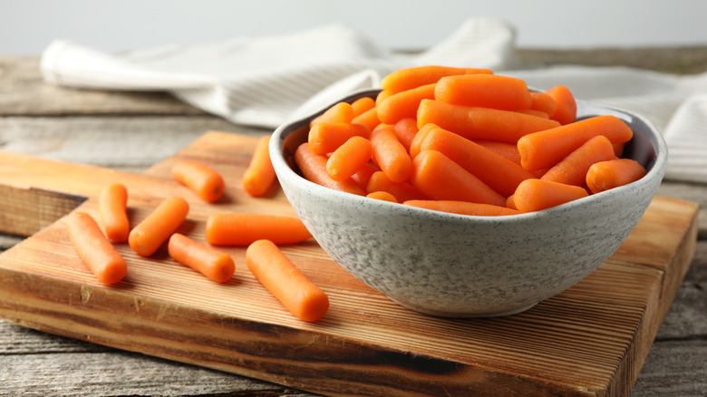 baby carrots in wooden bowl