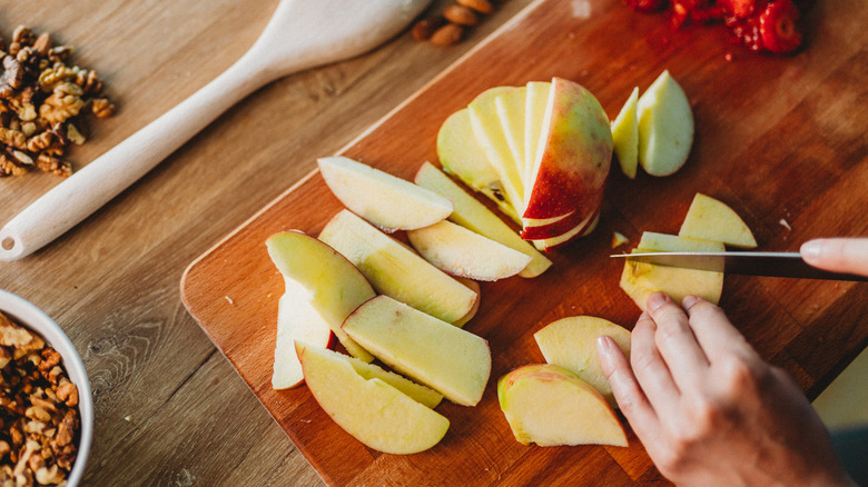 chopping apples on cutting board