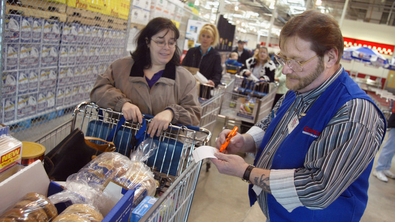 Costco employee checking a receipt