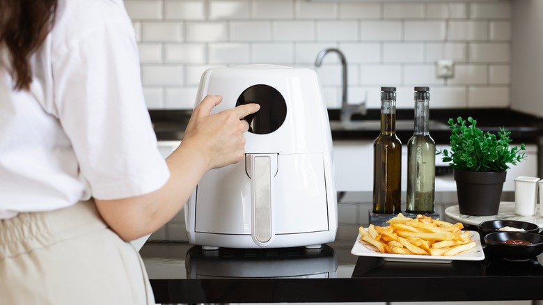 woman cooking with air fryer