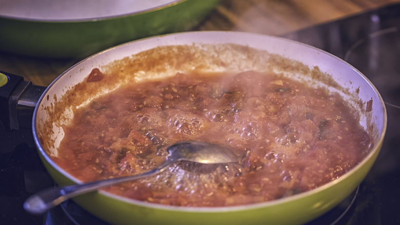 cooking tomato sauce in pan 