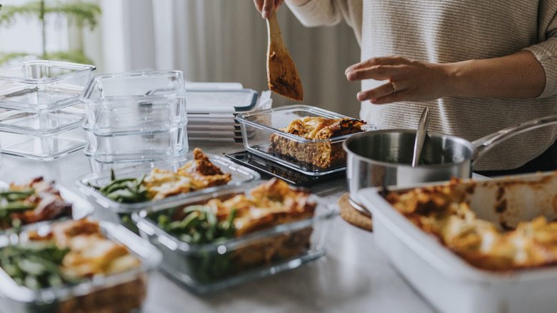 Woman meal prepping in tupperware