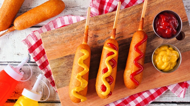 Corn dogs with mustard and ketchup