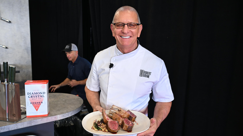 Robert Irvine showing meat dish