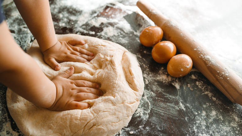 Hands kneading dough