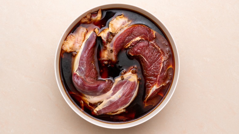 Meat marinating in a bowl