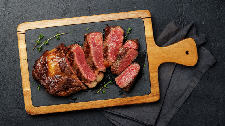 freshly cooked steak on a serving board