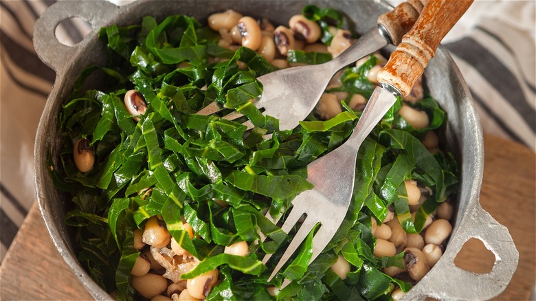 Collard greens topping a bowl of black eyed peas