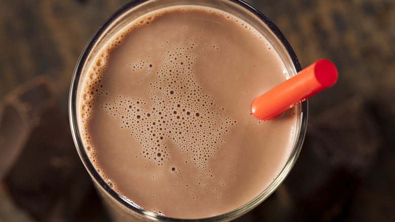 Chocolate milk shown from above with straw