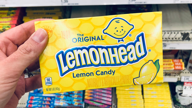 person holding box of Lemonheads