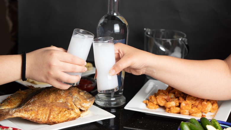 two friends toasting arak