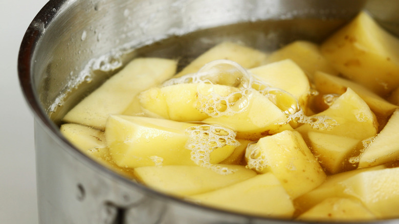 chopped potatoes in pot of water