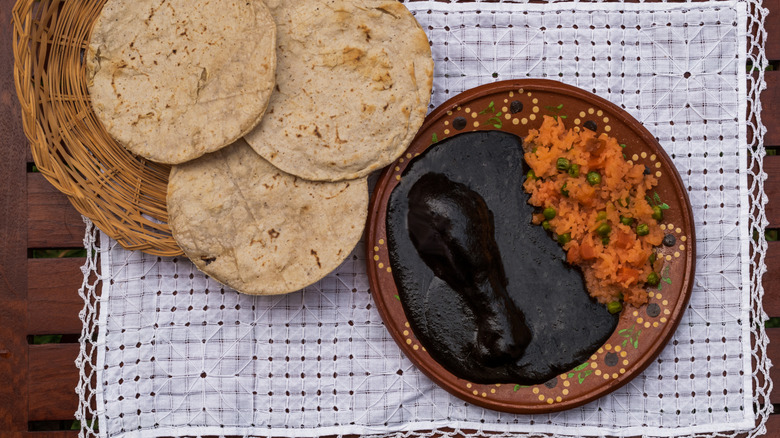 Mole negro, tortillas, and rice