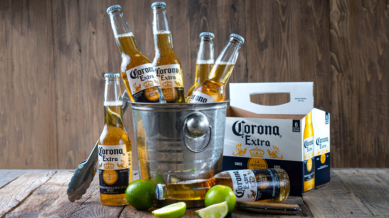 Coronas in an ice bucket with limes
