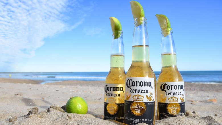 Bottles of Corona with lime on the beach