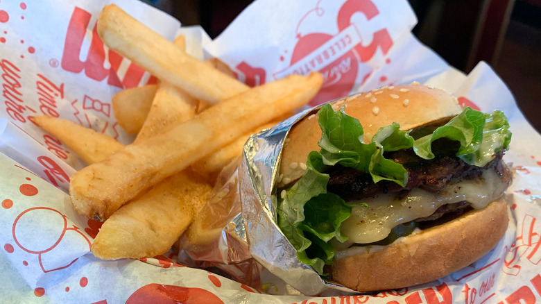 paper holding cheeseburger and fries