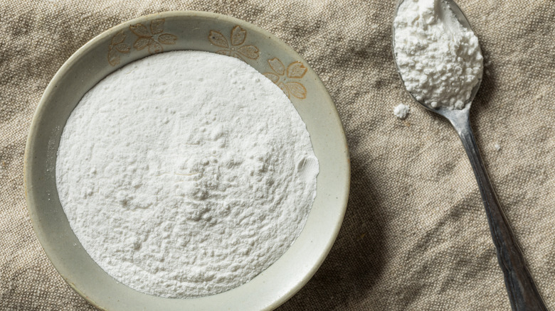 Cream of tartar in a bowl with spoon of tartar alongside