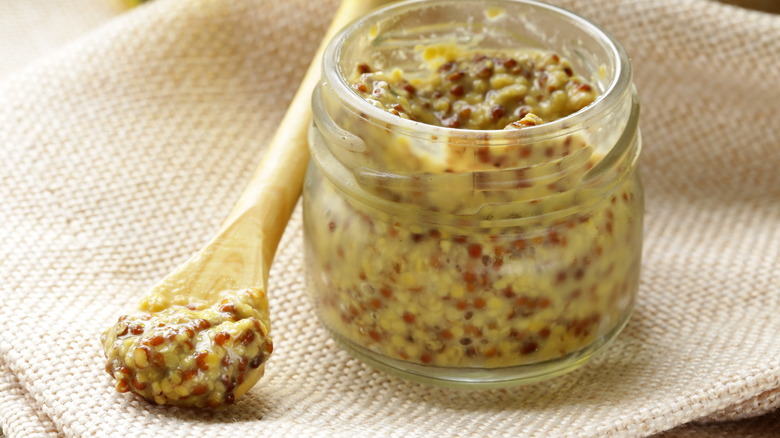 Small jar of coarse grainy mustard