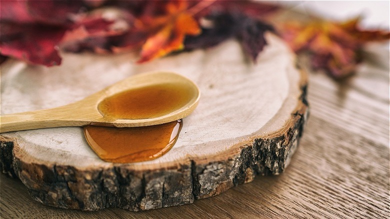 Maple syrup on wooden spoon 