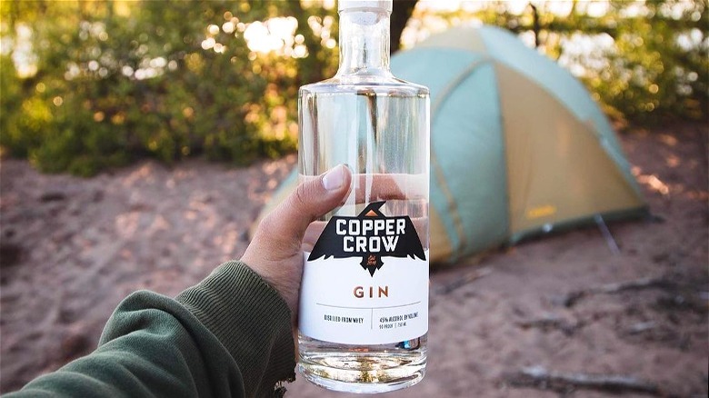 Hand holding Copper Crow Distillery gin 