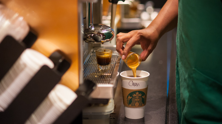 Starbucks barista pouring cream