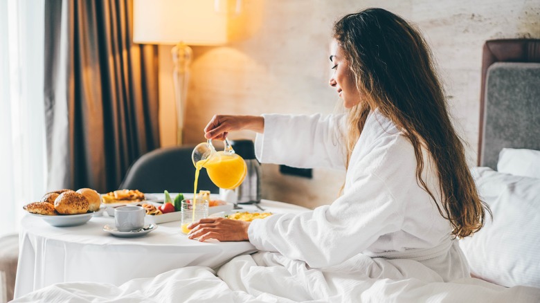 woman enjoying room service in bed 