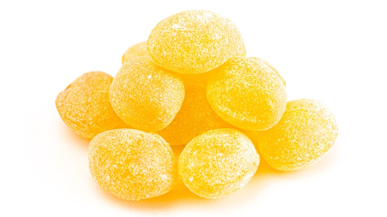 Sanded lemon candies on white background