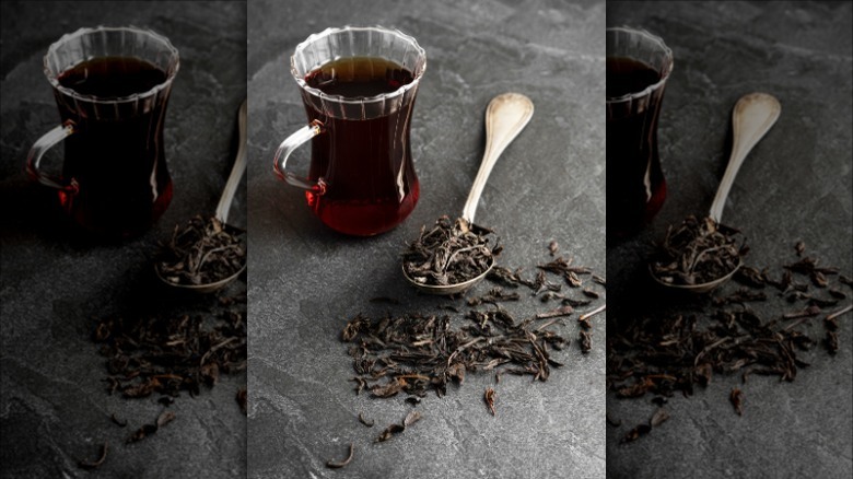 tea in pitcher and black tea leaves