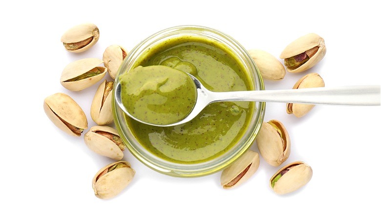 Jar of pistachio butter with spoon 