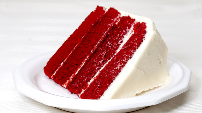 Slice of red velvet cake on white plate