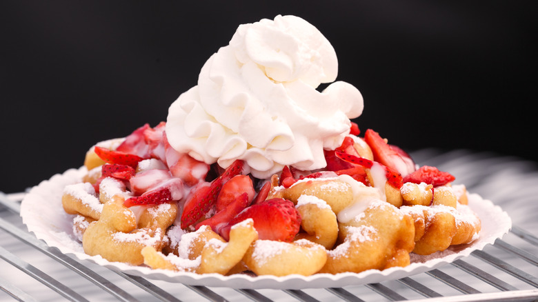 funnel cake with strawberries and whipped cream