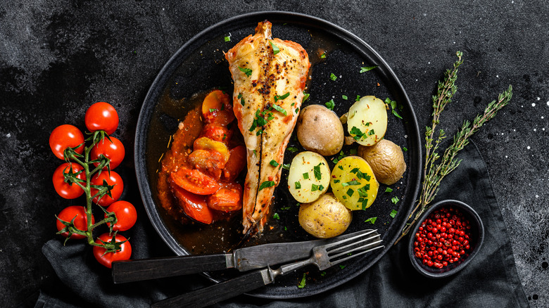 plated baked monkfish with potatoes and tomatoes