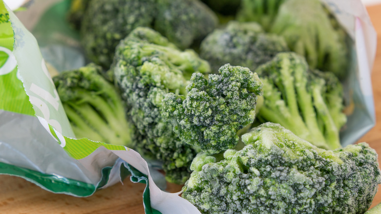 Frozen broccoli coming out of a bag